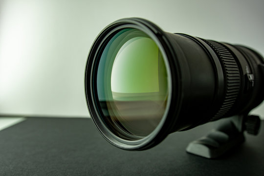 Close up photography of telephoto lens with reflections in the glass with no hood attached