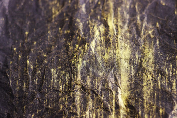 black crumpled surface with gold streaks for the background