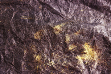 black crumpled surface with gold streaks for the background