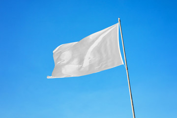 Waving white flag. Blank flag on flagpole mockup
