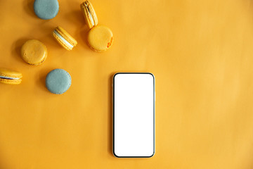 Top view of tasty orange yellow macarons.