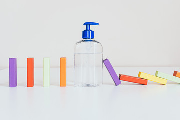 Stopping Chain reaction dominoes with hand sanitizing gel bottle. Stop propagation.