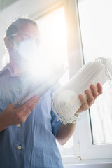 Woman doctor holding a lot of medical masks.