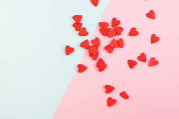 lots of little red hearts on a blue and pink background