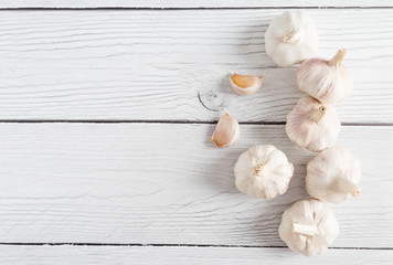 Garlic clove on white wood background