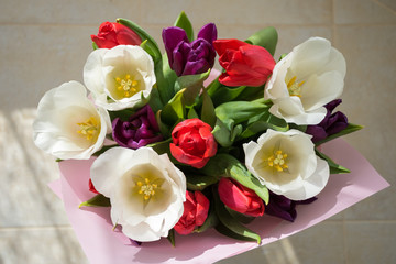 Spring floral arrangement. Bouquet of white, red and purple tulips