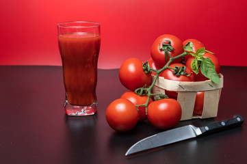 Tomato juice made from fresh tomatoes. Tomatoes and a knife. Cooking tomato juice.