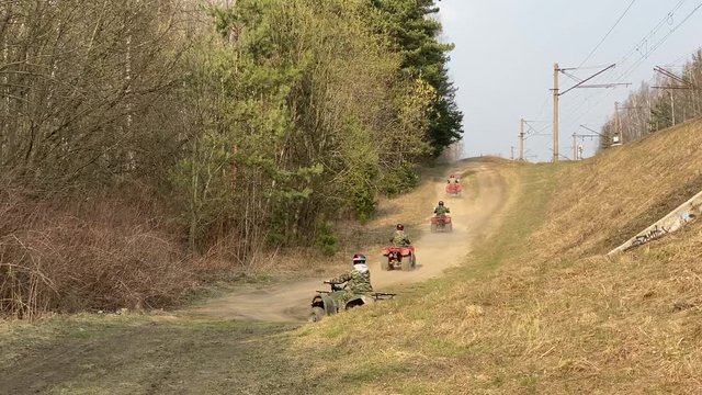 A row of ATV going on forest road