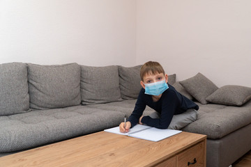 Isolated child Quarantined at Home in mask, Coronavirus Epidemic. Distance education and learning. Self isolation, home quarantine. World Crisis COVID-19. Distance learning at home. Place for text