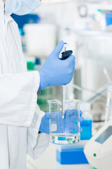 scientist in laboratory pipetting