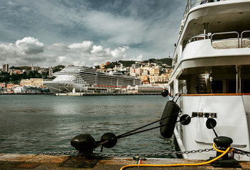 Luxury yachts and huge cruise ship in Genova port, Italy. Traveling with comfort concept image.
