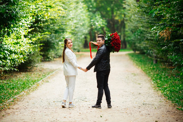 Fototapeta premium Beautiful loving couple spending time together in the park. Valentine's Day celebration