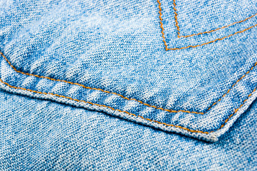 clothing items blue stonewashed faded jeans cotton fabric texture with seams, clasps, buttons and...
