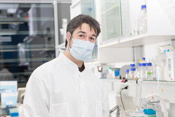 man with mouth protection in the laboratory
