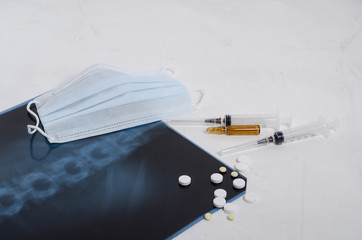 X-ray of the lungs, surgical medical mask and medication on a white background, pneumonia and...