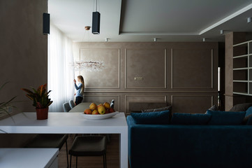 A girl in a new fashionable interior is talking on the phone. Interior shooting of an apartment