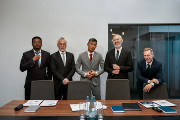 Team power. Group of successful business people in classic wear looking at camera while standing together in the modern office