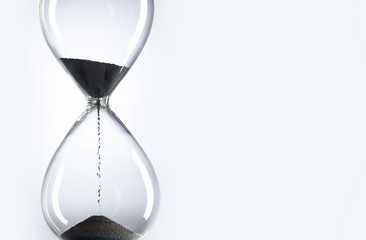 Time is money. Hourglass on white background. Black Sand in hourglass.