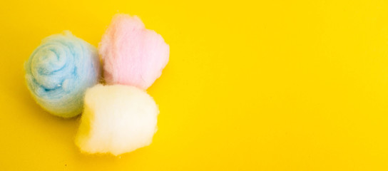 Banner colored cotton wool. Yellow background. Free copy space. Hygiene. Top view.