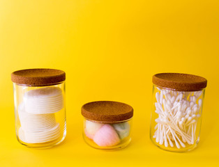 cotton swabs, colored cotton wool ball, cotton discs inside glass small container with wooden top....