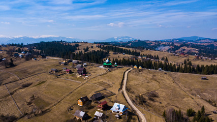 Alpine village settlement of a house on top of a mountain aerial photo Carpathians Ukraine.
