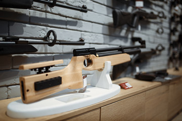 Pneumatic rifles on showcase in gun shop closeup