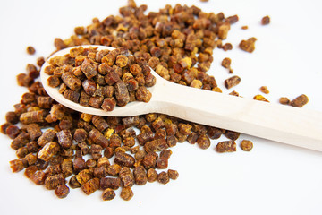 Bee bread (bee pollen, perga) on a wooden spoon 