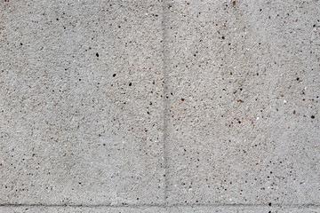 Cement wall imitating blocks of bricks. Two parts with space for text.