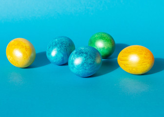 Colorful easter eggs on blue background. Happy Easter composition. Copy space.