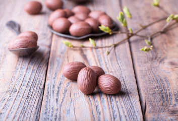 Delicious chocolate eggs on wood.
