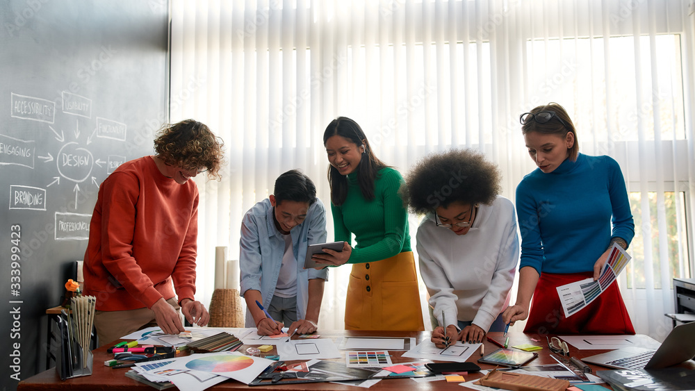 Aufkleber project team. group of multicultural creative people prototyping new web site design while having a 