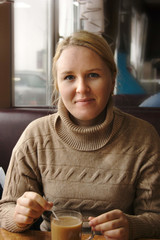 young woman in brown sweater