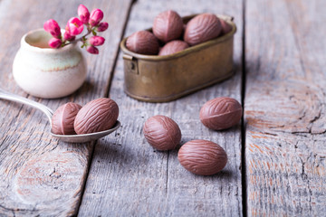 Delicious chocolate eggs on wood.