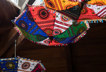 Beautiful decorative umbrellas hanging upside down from a ceiling.