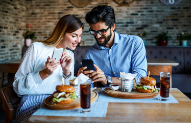 Young couple sitting in a cafe, having breakfast. Love, dating, food, lifestyle concept