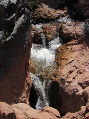 Closeup of a stream waterfall flowing down rocks on the Water Wheel Falls hiking trail in Payson, Arizona 