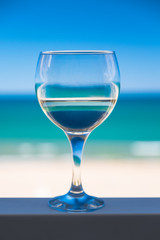 Glass of white wine on the background of the sea