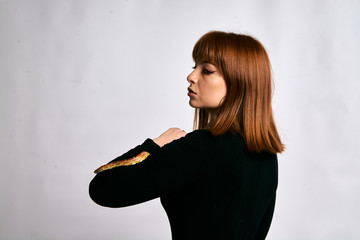 Beautiful woman in black bodywear and snake. Ginger model girl with fashion perfect make up.