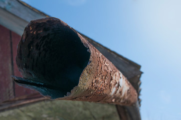 Drainpipe. Part of the roof of an old house.