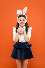 small girl wearing bunny ears on Easter day. Happy child in costume. Easter bunny rabbit with ears....