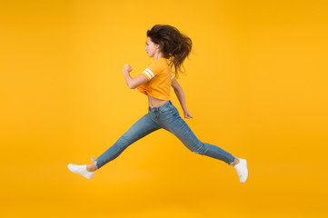 Fototapeta na wymiar Energy rush. Energetic girl in motion yellow background. Sexy woman in energetic movement. Moving with haste in energetic mood. Casual fashion style. Young and energetic. Fast but graceful
