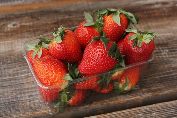 Delicious juicy strawberries on a wooden table