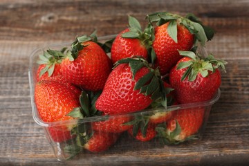 Delicious juicy strawberries on a wooden table