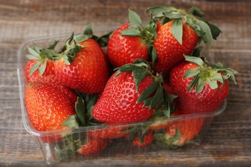 Delicious juicy strawberries on a wooden table