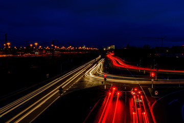 Night city road in Germany with blurred light tracks from cars