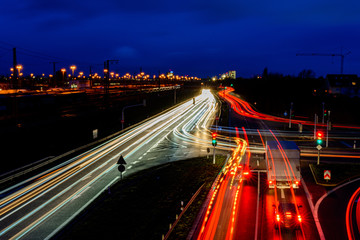 Night city road in Germany with blurred light tracks from cars