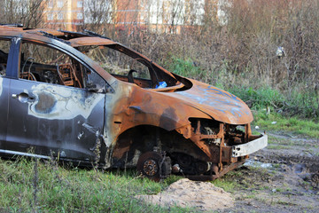 burnt car on the forest, rusty metal