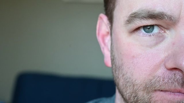 White Caucasian male repeatedly lifting eyebrow in slow motion