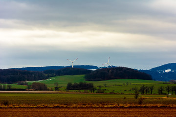 Windmills in mountain fields on the border of Germany and Poland