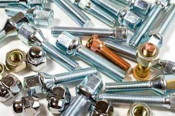 New car wheel studs on white table - auto parts